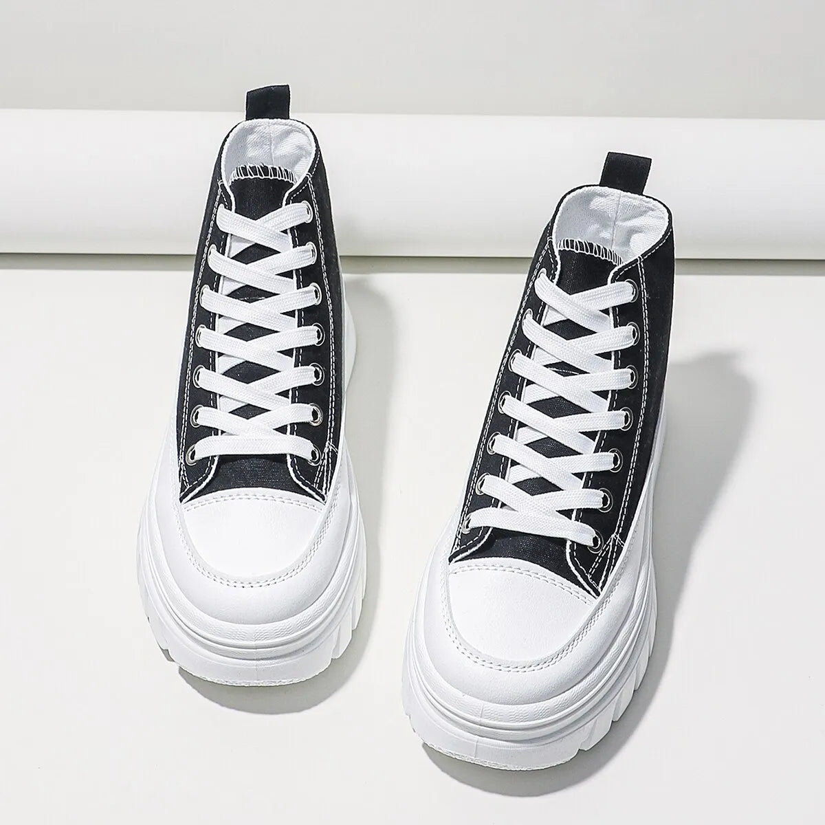 White canvas sneakers with thick sole